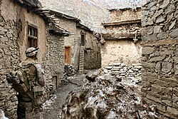 A US Navy Corpsman searches for Taliban fighters in Mihtarlam, 2005