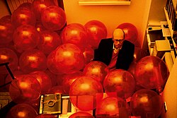 Martin Creed, Work No. 204, Half the air in a given space on display in Turin, Italy, 1999. The gallerist, Alberto Peola, sits in his office during the exhibition