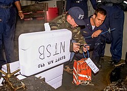 FBI agent tagging the cockpit voice recorder from EgyptAir Flight 990 on the deck of USNS Grapple at the crash site on November 13, 1999