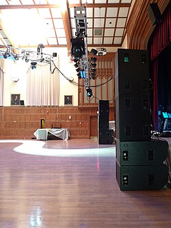 A sound reinforcement setup with subwoofers for the bass range (the cabinets on the floor) and full range cabinets for the mid and high frequencies (stacked on top).