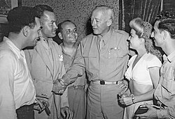 Writer Hal Block (far left), comedian Bob Hope (second from left), writer/actor Barney Dean, singer Frances Langford and musician Tony Romano meet George Patton in Sicily during World War II.