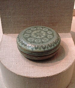 A Korean stoneware cosmetic box with white and black inlay and a celadon glaze, from the Goryeo Dynasty, dated c. 1150–1250