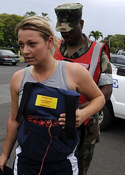 A U.S. Navy servicewoman poses as a captured female suicide bomber during the OPFOR exercise in Pearl Harbor, Hawaii