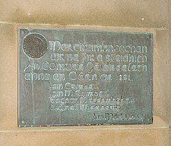 Plaque commemorating the founders of the Comunn Gàidhealach in Oban in 1891, using the Insular script for decorative purposes