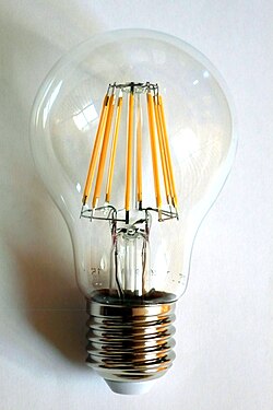 A 230-volt LED filament lamp, with an E27 base. The filaments are visible as the eight yellow vertical lines.