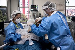Medical professionals treating a COVID-19 patient in critical condition in an intensive care unit in May 2020.