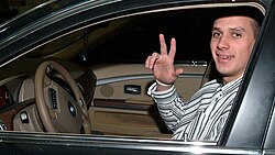 NBA basketball player Aleksandar Pavlović gesturing the three-finger salute.