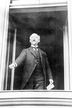 Philipp Scheidemann proclaims the republic from the Reichstag building on 9 November 1918.