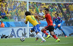 Marcelo taking on Rafael Márquez at the 2014 FIFA World Cup