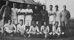 The football team of 95 Company, Royal Garrison Artillery, victors in the 1917 Governor's Cup football match, pose with the cup. The cup was contested for annually by teams from the various Royal Navy and British Army Bermuda Garrison units stationed in Bermuda.