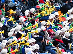 A 2010 FIFA World Cup crowd blowing vuvuzelas