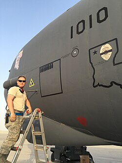 B-52 Crew Chief SSgt Figueroa stenciling completed bombing sorties on B-52H (61–0010) during Operation Inherent Resolve, in part of the Military intervention against ISIL at Al Udeid Air Base, in Qatar