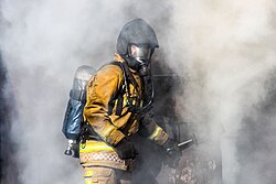 A Staffordshire Fire and Rescue Service firefighter, training in a smoke house