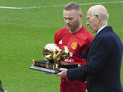 Wayne Rooney receiving an award for becoming the club's record goalscorer from previous record holder Sir Bobby Charlton in January 2017