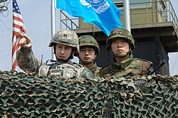 US Army officer confers with South Korean soldiers at Observation Post (OP) Ouellette, viewing northward, in April 2008