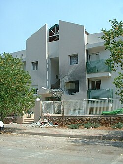 Structural damage of a residential building in Kiryat Shmona after being hit by a rocket