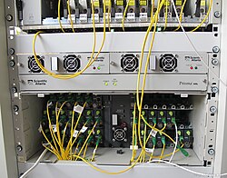 Scientific Atlanta HDRx chassis with many receiver modules for receiving data from customers, which is their internet upload bandwidth in this case in an HFC coaxial network, it converts optical signals in fiber optics into RF signals in coaxial cables