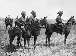 Forward scouts of the 9th Hodson's Horse pause to consult a map, near Vraignes, France in April 1917