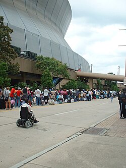 Displaced people bringing their belongings and lining up to get into the Superdome