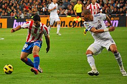 Agüero (left; pictured with Pepe) with Atlético Madrid during the 2010–11 season
