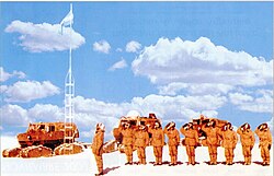 Soldiers saluting the flag at the South Pole.