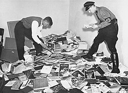 A German student and a Nazi SS member plunder the library of Dr. Magnus Hirschfeld, Director of the Institute for Sexual Research in Berlin.