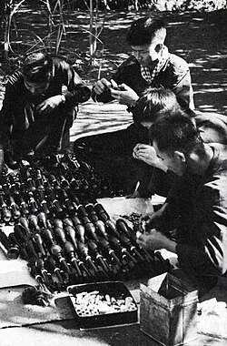 Guerrillas assemble shells and rockets delivered along the Ho Chi Minh Trail.