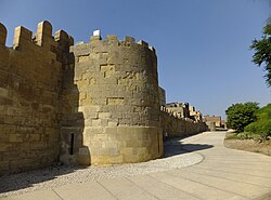 The 12th-century Ayyubid wall of Cairo, as seen from present-day al-Azhar Park. This wall was part of an ambitious fortification project begun by Saladin in 1176 that also included the construction of the Cairo Citadel.[179]