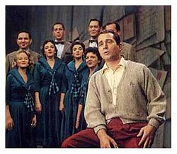 Como and the Ray Charles Singers on the set of The Perry Como Show during "Sing To Me, Mr. C." segment, c. 1950s. Como's "sweater era".