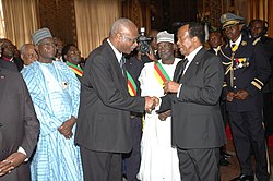 Philémon Yang shaking hands with President Paul Biya in 2012.