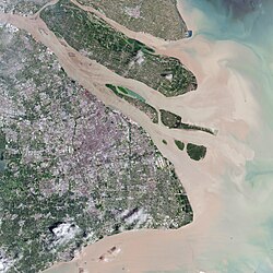 The urban area of Shanghai in 2016, along with its major islands. From northwest to southeast: Chongming, Changxing, Hengsha, and the Jiuduansha shoals off Pudong. The Yangtze's natural sediment discharge can be seen.