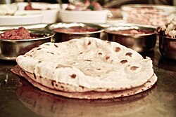 Roti, served with various side dishes, is considered a staple food in Pakistan