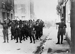 Canadian prisoners being led away through Dieppe after the raid. Credit: Library and Archives Canada / C-014171