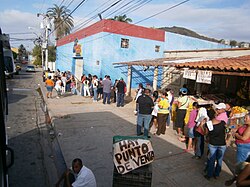 Shoppers waiting in line at a government-run MERCAL store