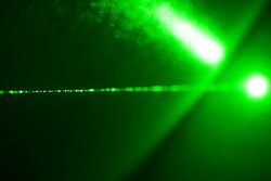 A laser can produce a very narrow beam of light of a single wavelength, in this case, green.