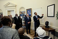 President Barack Obama views the Emancipation Proclamation in the Oval Office hung above a bust of Martin Luther King Jr. in 2010