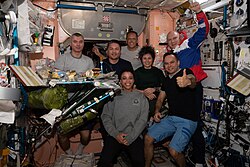 The Expedition 67 crew during a group dinner in Unity
