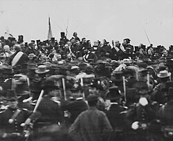 One of only two confirmed photos of Lincoln at Gettysburg (seated in center facing camera),[215][216] taken about noon on November 19, 1863; some three hours later, Lincoln delivered the famed address. To Lincoln's right is Ward Hill Lamon, Lincoln's bodyguard.