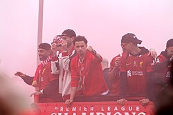Salah (left) with his teammates during Liverpool's Premier League title-winning parade on 26 May 2025 celebrating the club's record-equalling 20th league title.