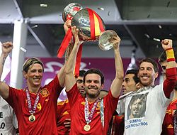 Spanish footballers Fernando Torres, Juan Mata, and Sergio Ramos celebrating winning the UEFA European Championship in 2012