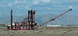 Mallard II, a clamshell dredge built in 1936 and used into the 21st century to dredge levees for Cargill's salt ponds in the bay