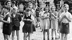 Photo taken by Maurice Rossel at Theresienstadt. Most of the children were murdered at Auschwitz in the fall of 1944.[50][c]
