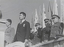 Kim (black suit) attending a mass event with members of the Soviet Civil Administration, Pyongyang, October 1945[61]