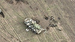 Russian casualties next to a Z marked armoured vehicle