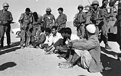 Israeli soldiers check Palestinian men in Gaza in 1969