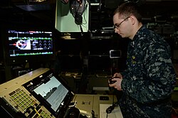A sailor using an Xbox 360 controller to control the photonic masts of the USS Colorado (SSN-788) in 2018. It is the first submarine to use this tens of dollar controller instead of Lockheed Martin's billed joystick $38,000.