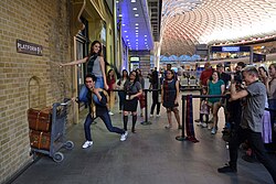 Tourists at Platform 9+3⁄4 in the western departures concourse