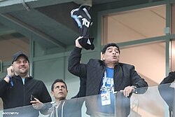 Maradona at the 2018 FIFA World Cup in Russia, where he was treated by paramedics after collapsing following Argentina's victory over Nigeria[326]
