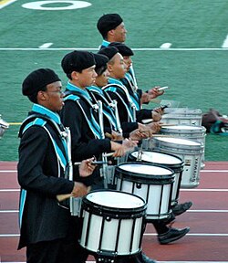 A line of marching snare drums in a high school marching band