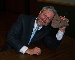 Neil Shubin, one of the paleontologists who discovered Tiktaalik, holding a cast of its skull